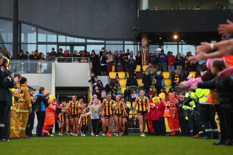 MELBOURNE, AUSTRALIA - OCTOBER 25: Laura Elliott of the Hawks leads the team out during the round 11 AFLW match between Hawthorn Hawks and Essendon Bombers at Kennedy Community Centre, on October 25, 2026, in Melbourne, Australia. (Photo by Daniel Pockett/AFL Photos)